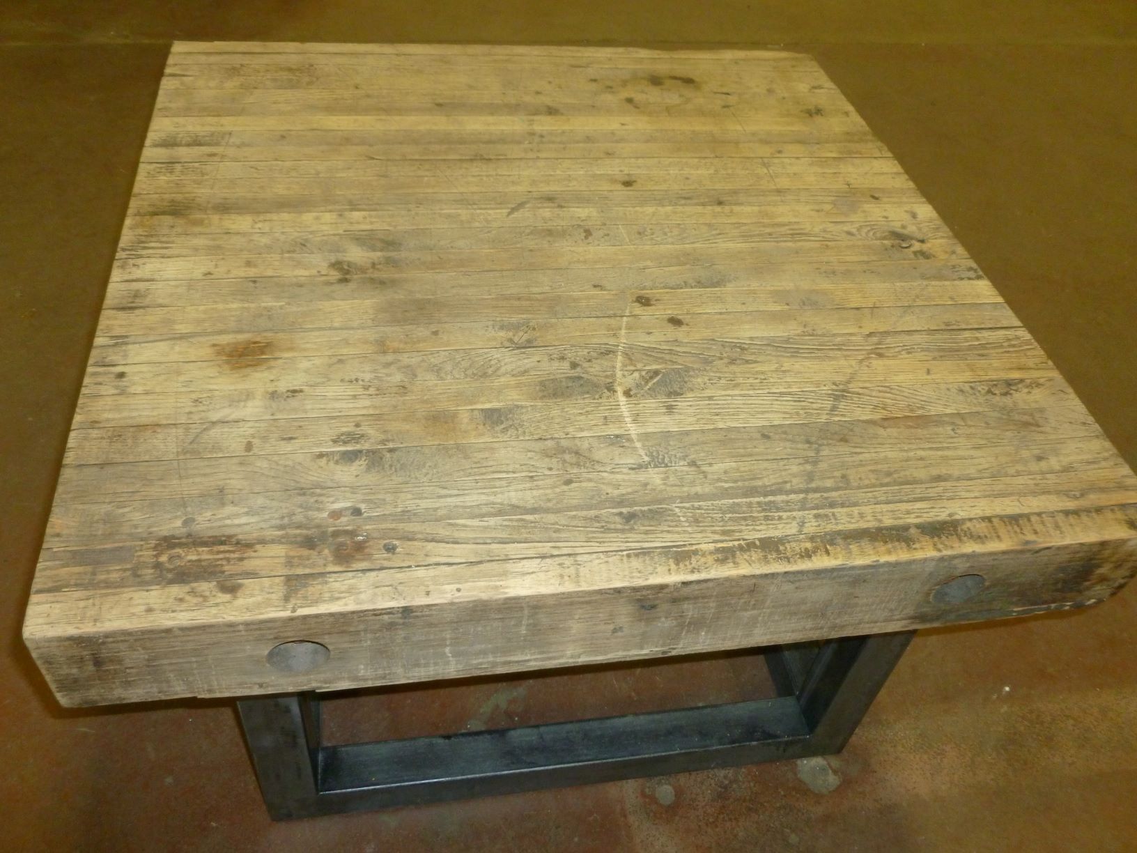 Ferro Designs LLC custom iron coffee table with a steel base finish and a reclaimed factory flooring top.