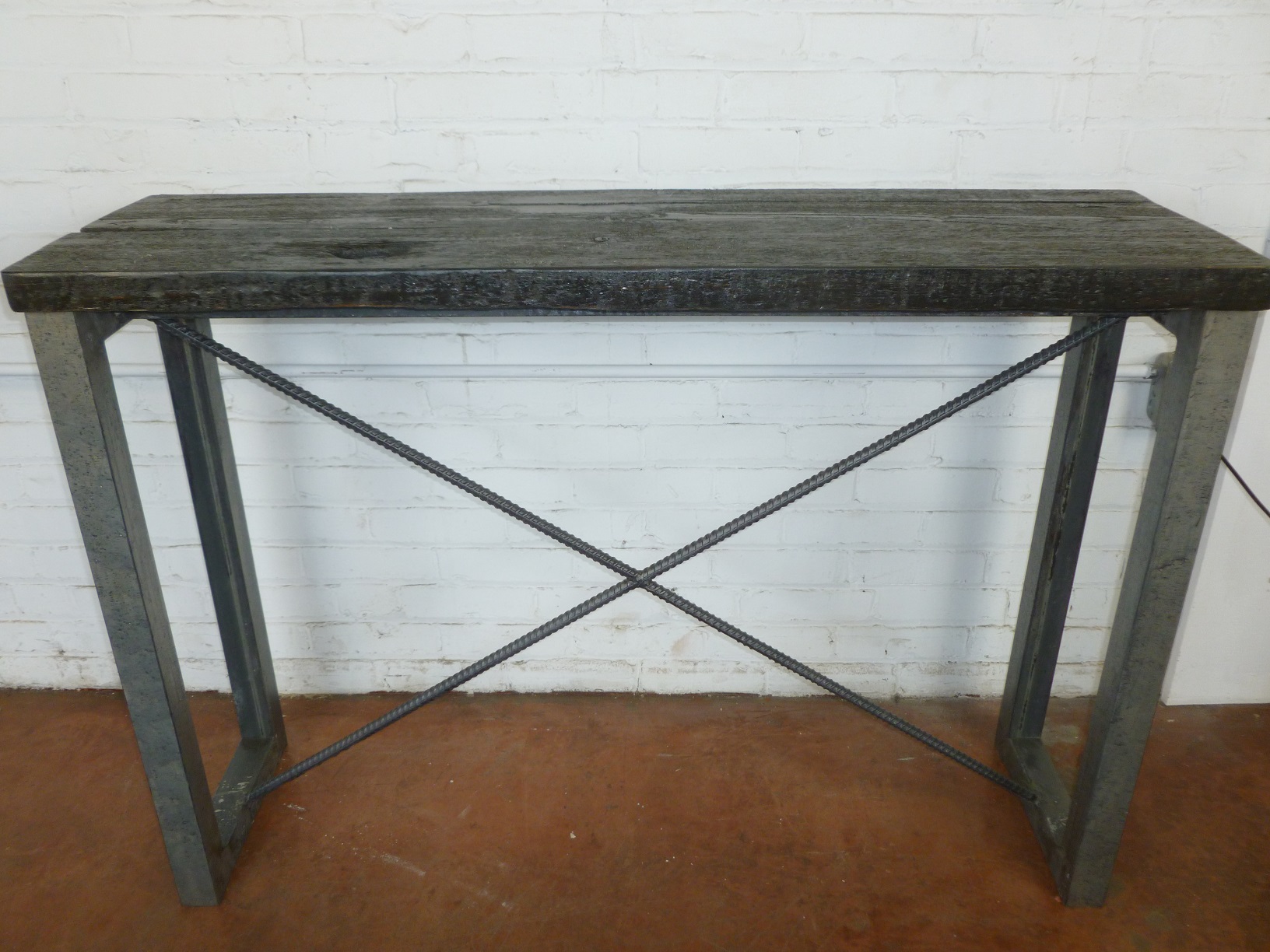 Custom iron console table by Ferro Designs LLC with a barn wood top and a steel finish base.