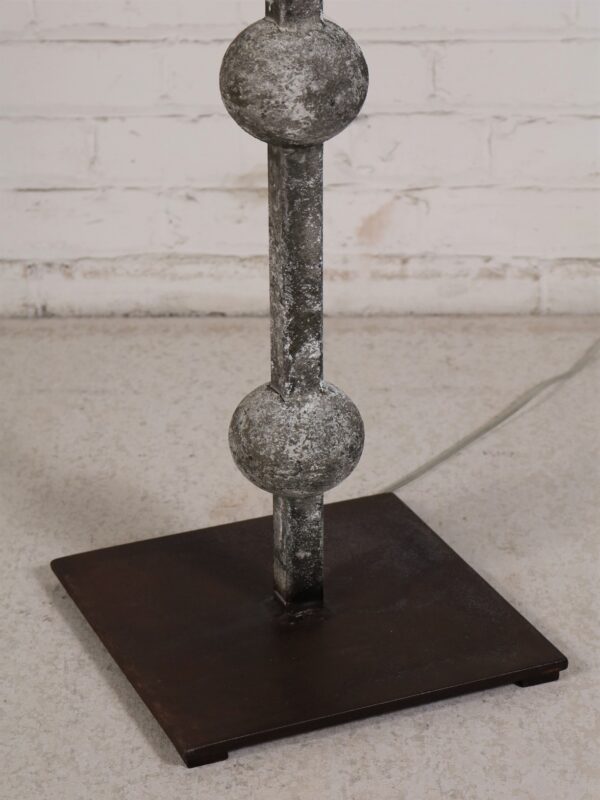 Custom iron floor lamp with a gray, distressed finish and a dark iron base.