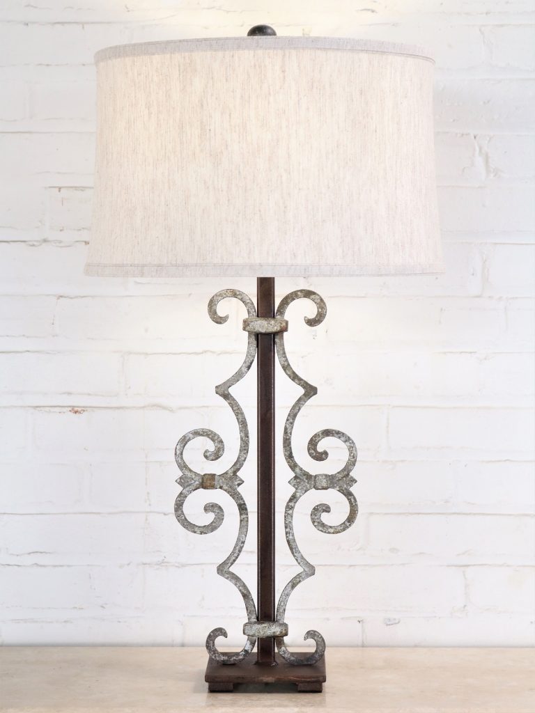 Scroll custom iron table lamp with white, distressed finish on a dark iron base