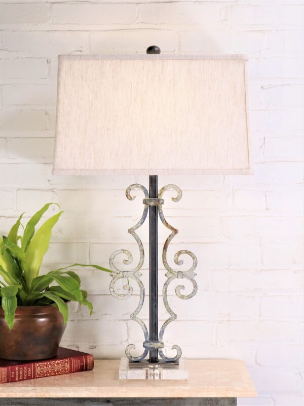 Scroll custom iron table lamp with a white, distressed finish on an acrylic base