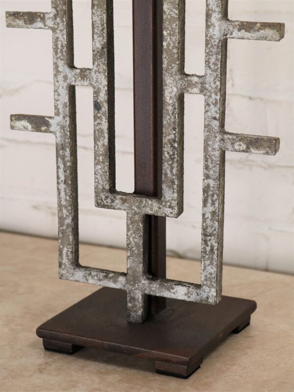 Geometric custom iron table lamp with a gray, distressed finish on a dark iron base.
