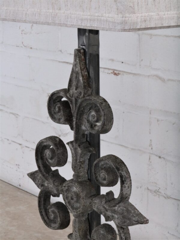 Cross custom iron table lamp with a gray, distressed finish on a dark iron base