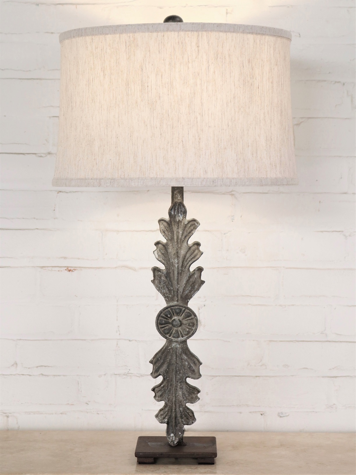 Leaf custom iron table lamp with a gray, distressed finish on a dark iron base