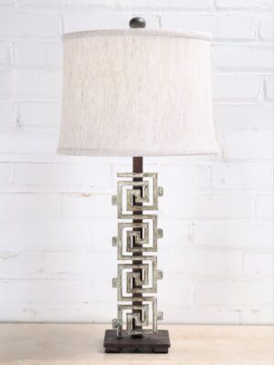 Meandros-greek key custom iron table lamp with a white, distressed finish and a dark iron base. Paired with a 12 inch drum linen lamp shade.