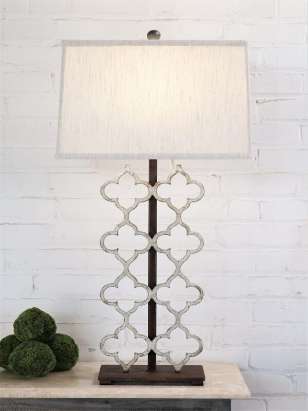 Quatrefoil custom iron table lamp with a white, distressed finish and a dark iron base. Paired with a 17 inch rectangle linen lamp shade.