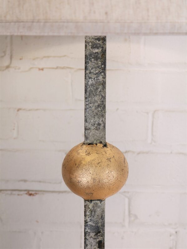 Gold leaf ball custom iron table lamp with a white, distressed finish.