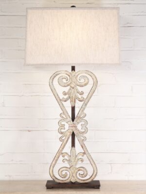 Flower bow custom iron table lamp with a white, distressed finish and a dark iron base. Paired with a 19 inch rectangle linen lamp shade.