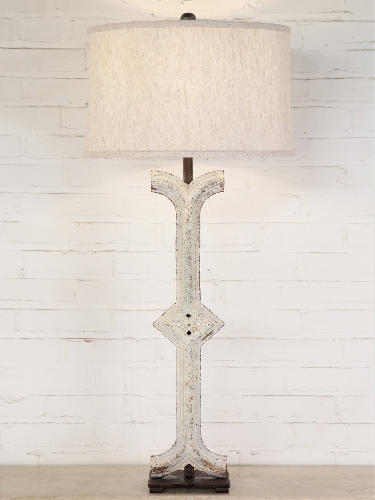 Diamond column custom iron table lamp with a white, distressed finish and a dark iron base. Paired with a 17 inch linen drum lamp shade.