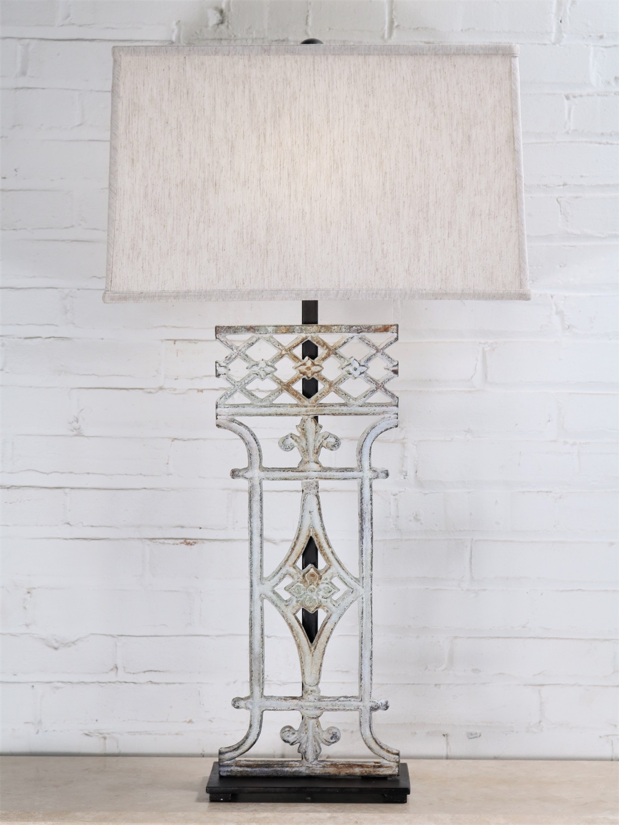 French custom iron table lamp with a white, distressed finish and a dark iron base. Paired with a 19 inch rectangle linen lamp shade.