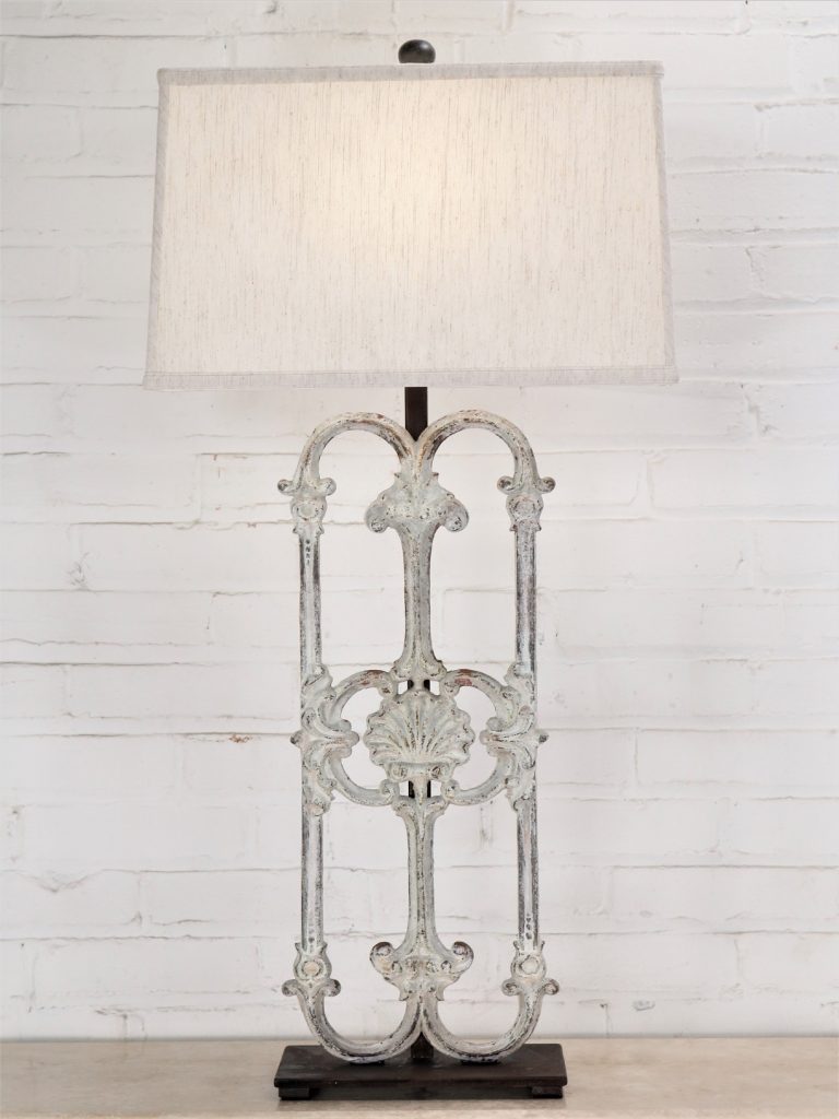 Shell custom iron table lamp with a white, distressed finish and a dark iron base. Paired with a 17 inch rectangle linen lamp shade.