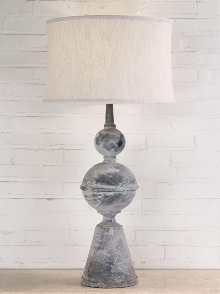 Large finial custom iron table lamp with a gray, distressed finish. Paired with a 19 inch linen drum lamp shade.