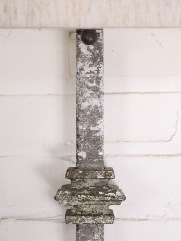 Custom iron wall sconce with a gray, distressed finish.