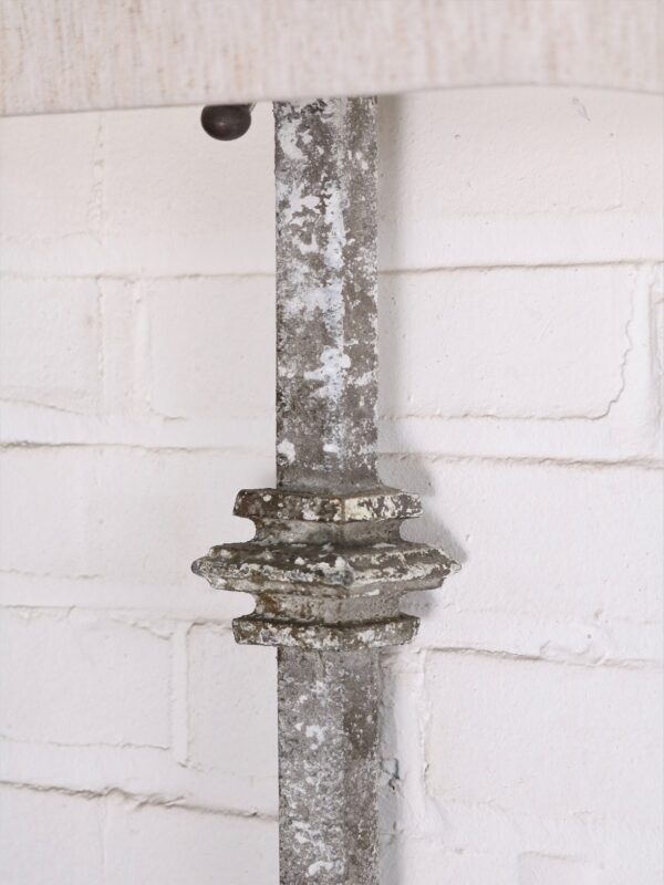Custom iron wall sconce with a gray, distressed finish.