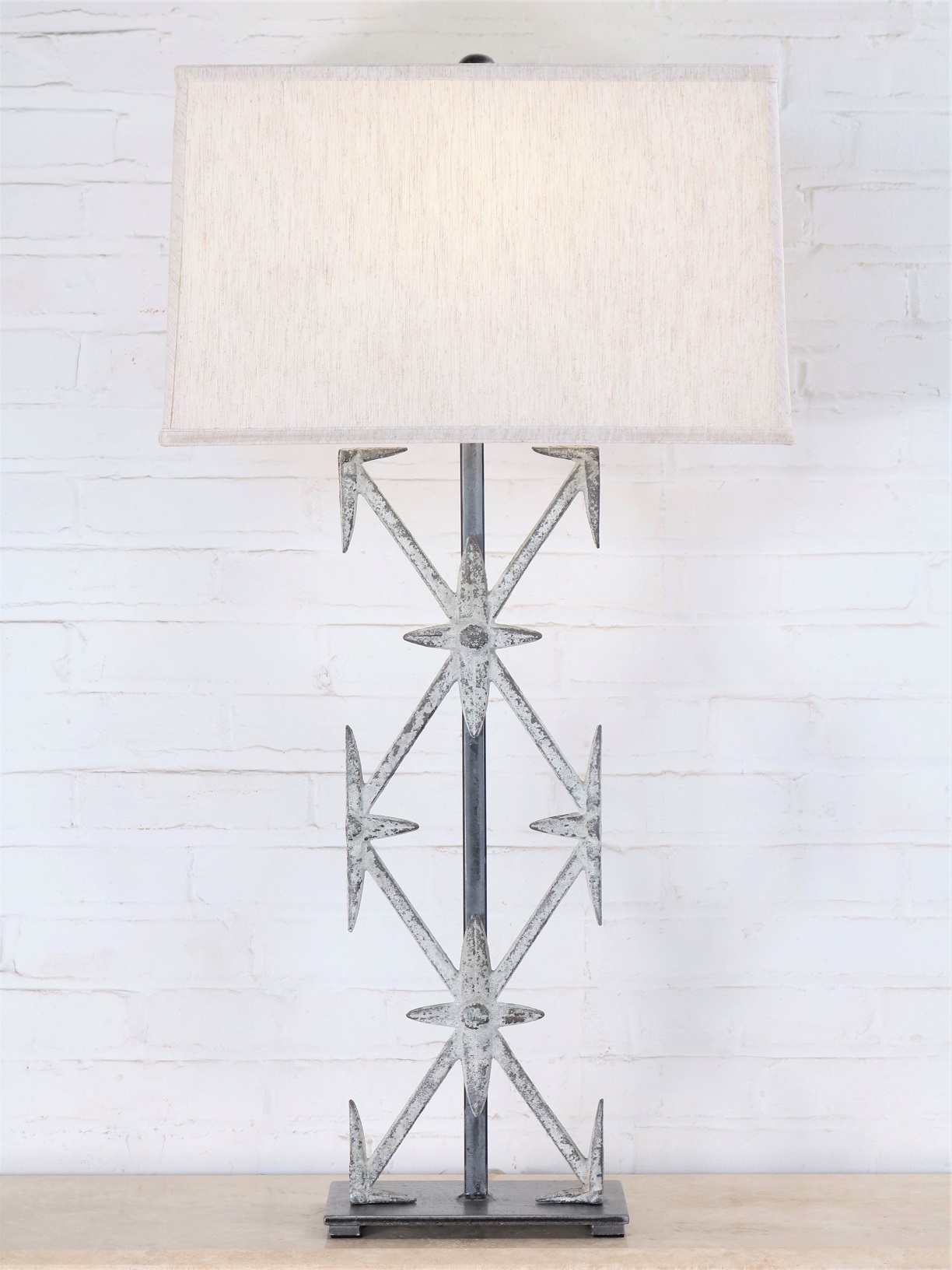 Ferro Designs LLC custom iron table lamp with a white, distressed finish and a pewter base. Paired with a 19 inch rectangle linen lamp shade.