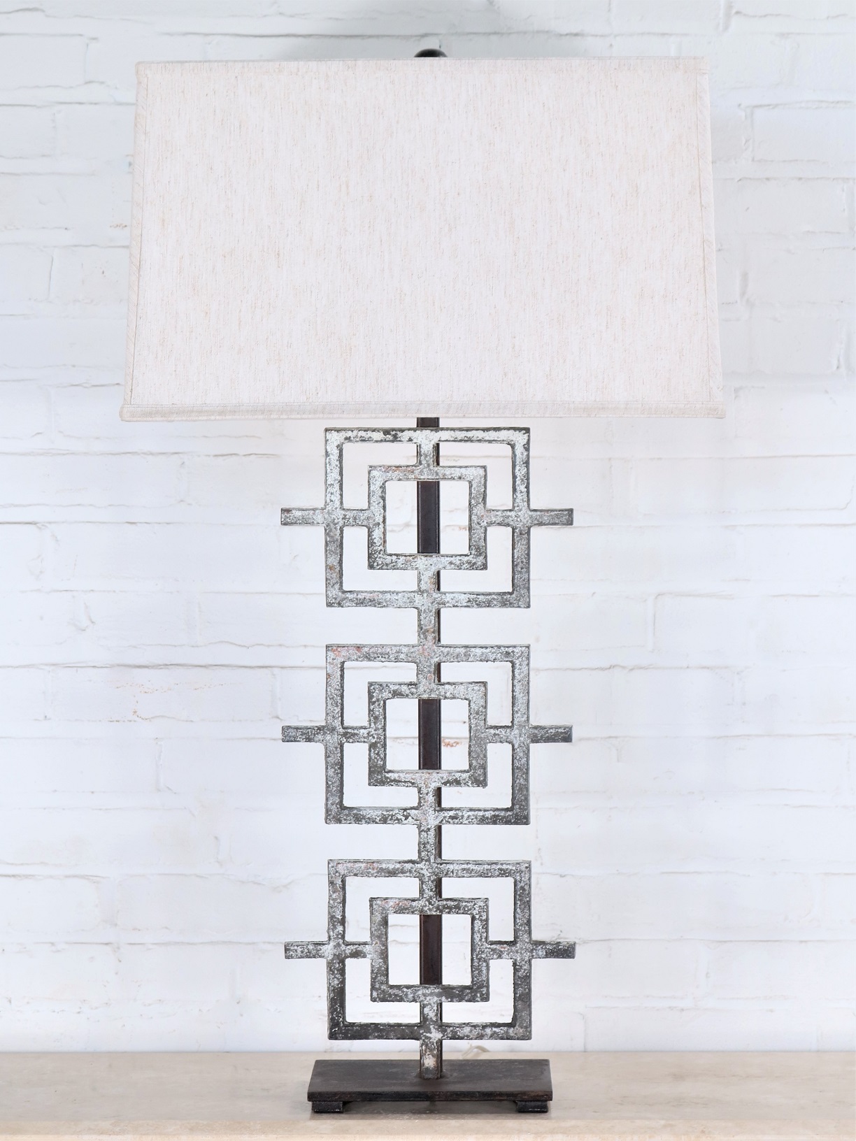 Ferro Designs LLC custom iron table lamp with a white, distressed finish and a dark iron base. Paired with a 19 inch rectangle linen lamp shade.